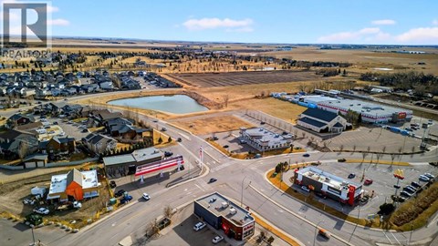 A small town with a large open field in the middle of it.
