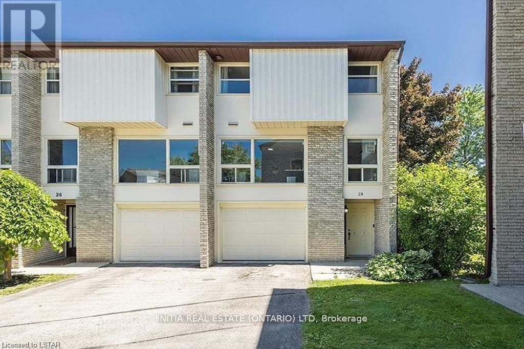 A modern two-story residential building with a garage on the ground floor.