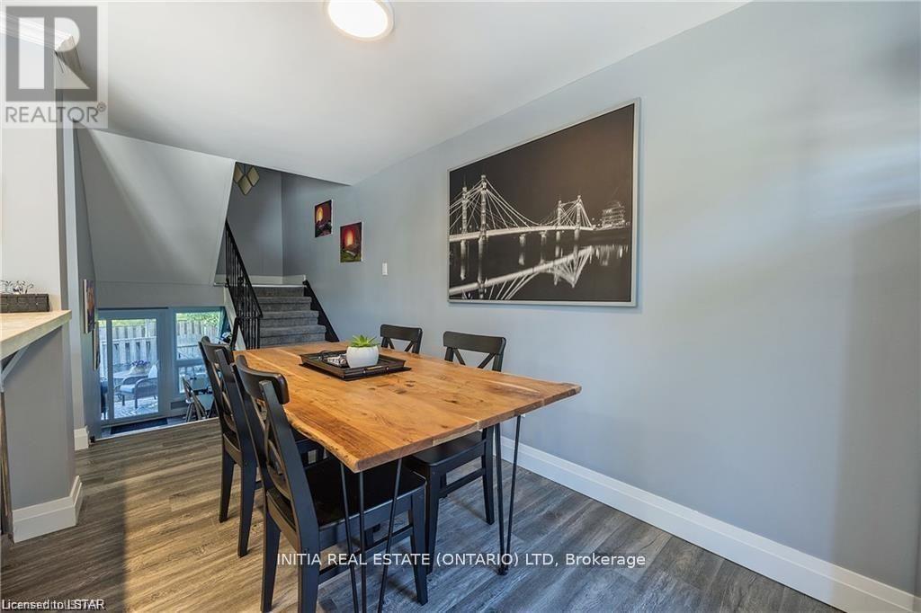 A dining room with a wooden table and chairs.