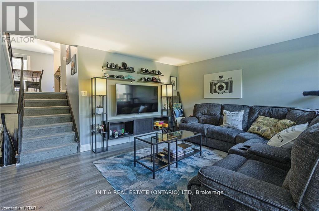 A living room with a couch, a coffee table, and a television.