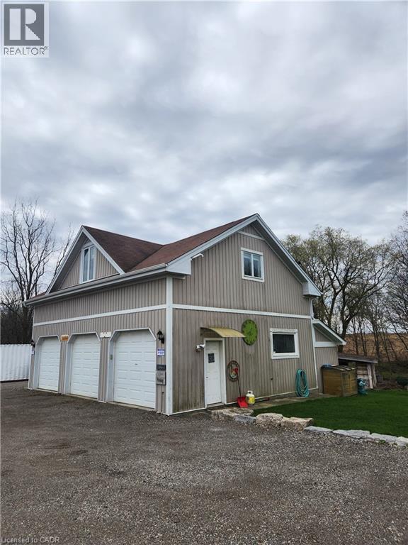 A two-story house with a garage and a driveway.