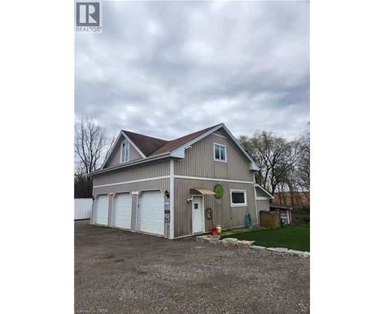 A two-story house with a garage and a driveway.