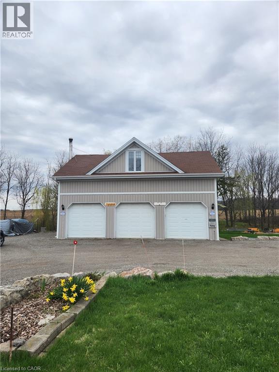 A two-car garage with a house attached is for sale.