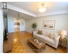 A living room with a couch, coffee table, and television.