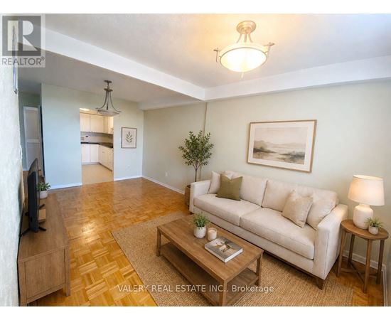A living room with a couch, coffee table, and television.