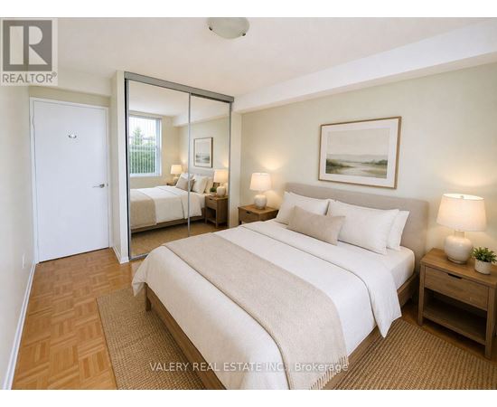 A bedroom with a large bed, a mirror, and a painting on the wall.