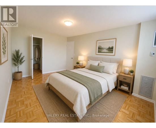 A bedroom with a large bed and a plant in a pot.