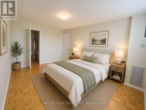A bedroom with a large bed and a plant in a pot.