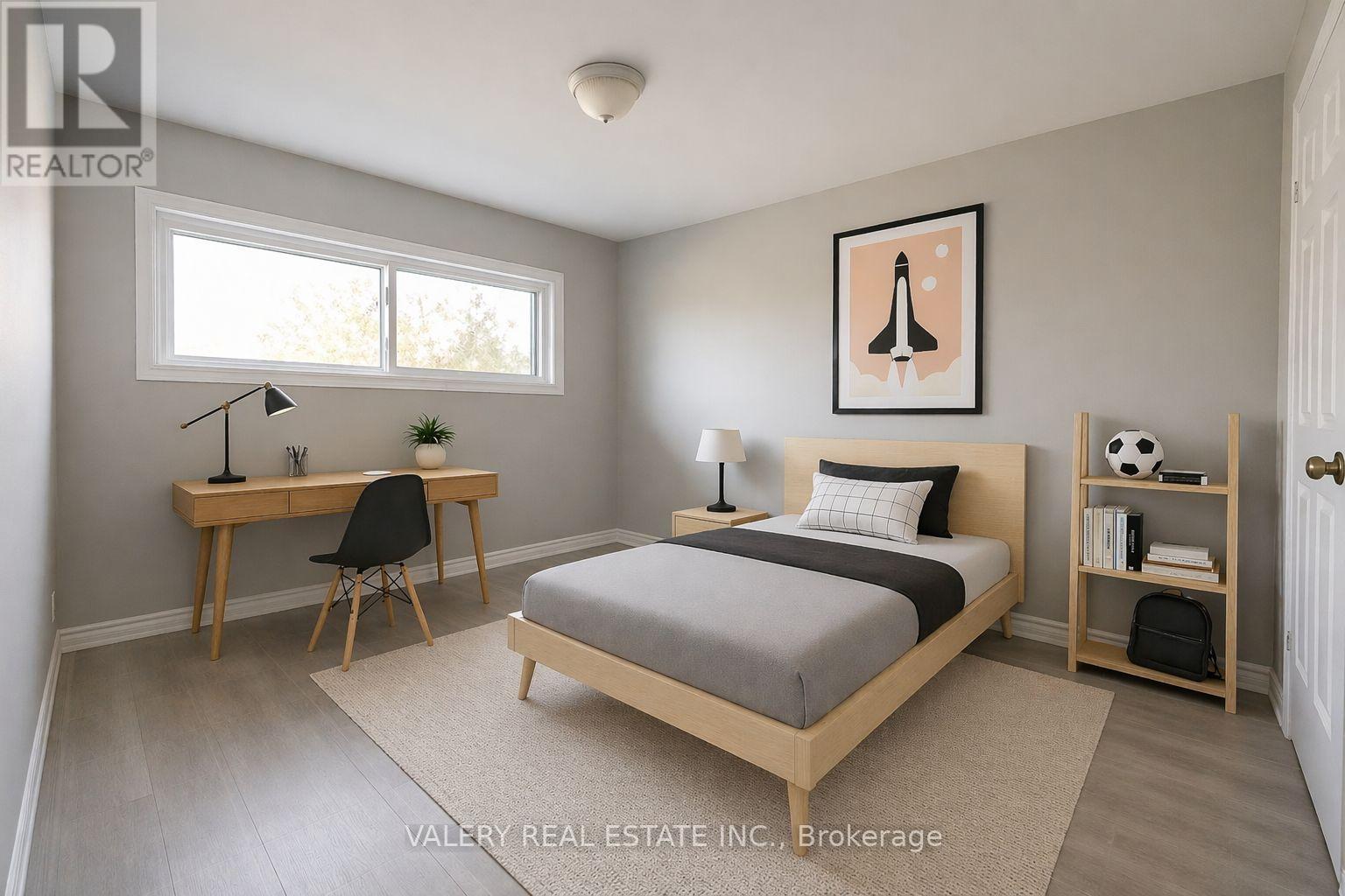 A bedroom with a bed, desk, and chair.