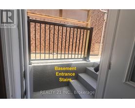 Basement entrance stairs with a railing.