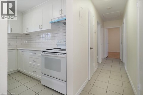 A white kitchen with a white oven and white cabinets.