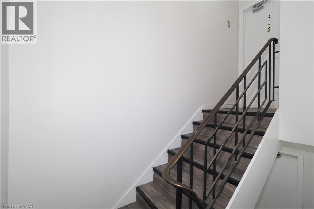 A staircase with a metal railing and wooden steps.