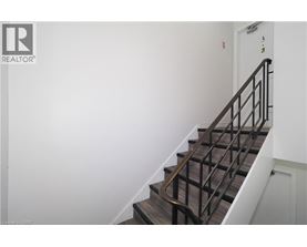 A staircase with a metal railing and wooden steps.