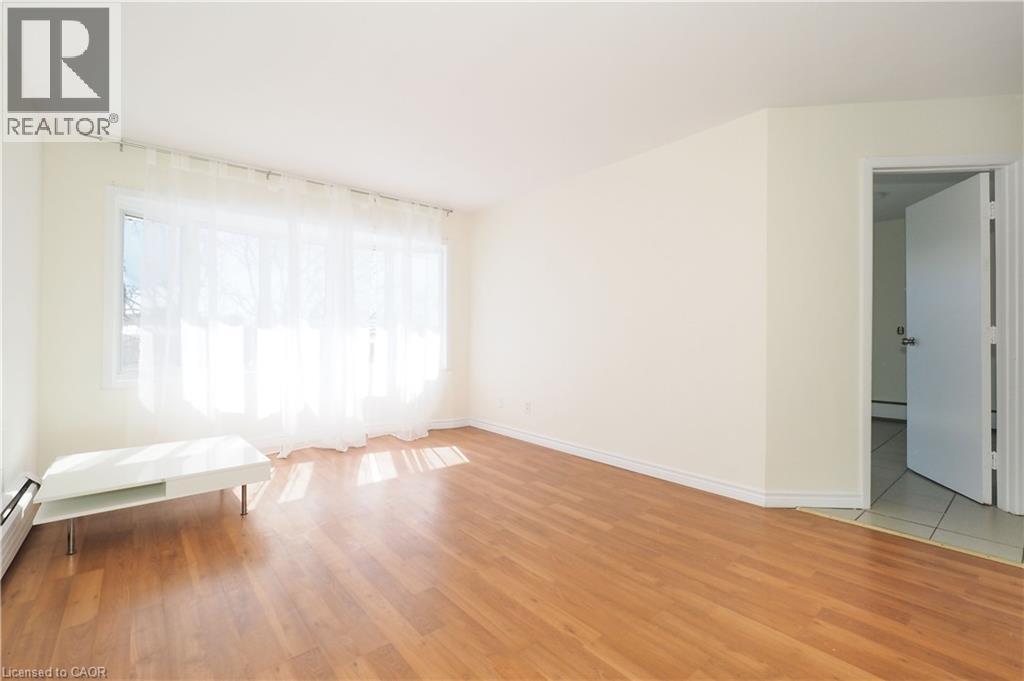 A bedroom with a bed and a wooden floor.
