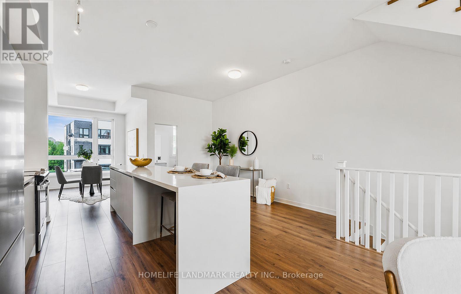 A white kitchen with a dining table and chairs.