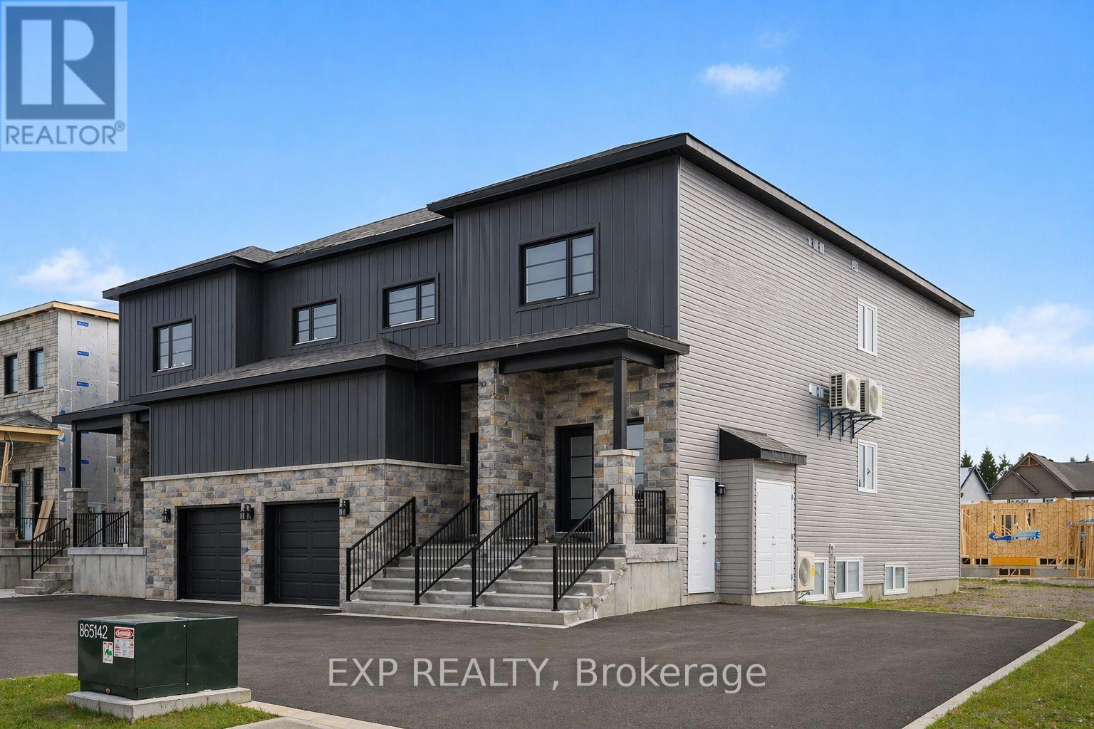 A modern building with a stone facade and a metal roof is for sale.