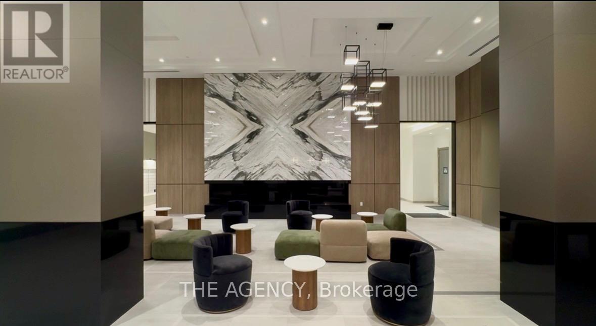 A modern office lobby with a marble floor and a large abstract painting.