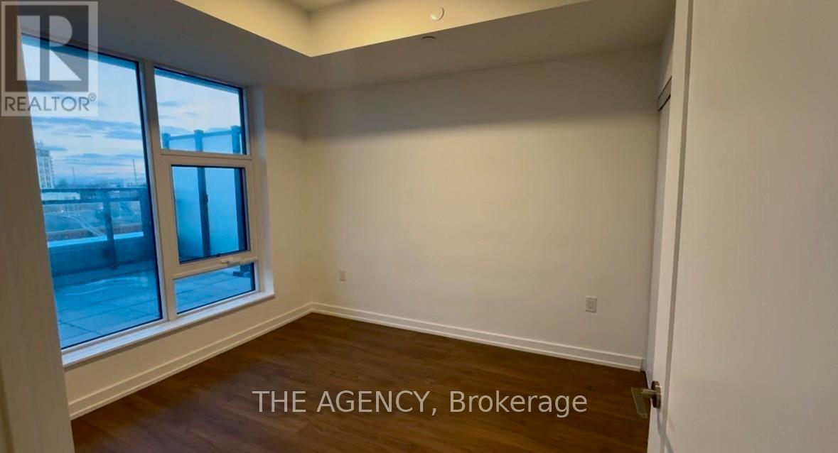 A room with a window and a sign that says "THE AGENCY, Brokerage".