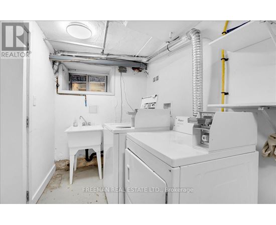 A white sink and table in a small room.