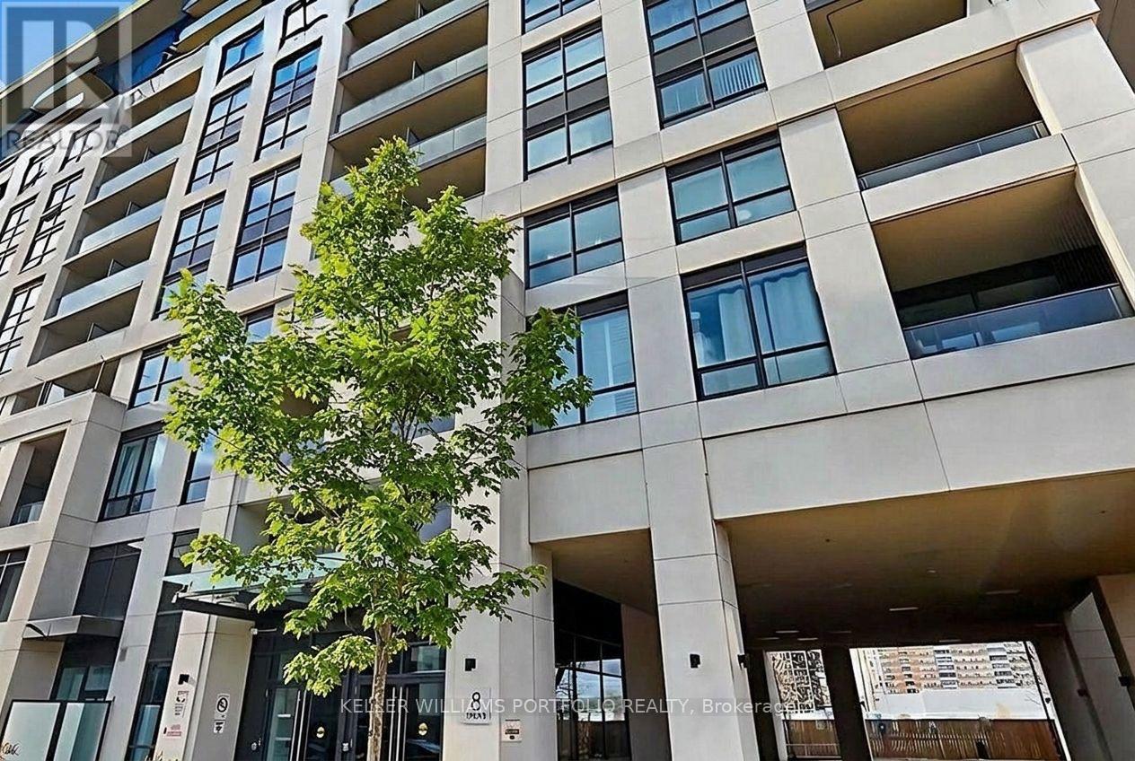 A tall building with a tree in front of it.