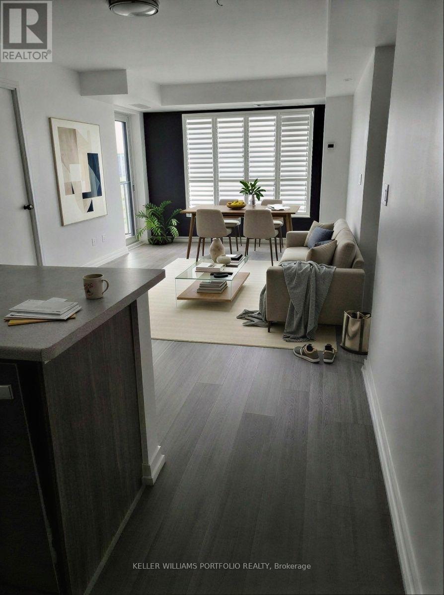 A living room with a couch, chair, and table.