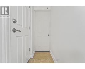 A white door with a silver handle and a small window above it.