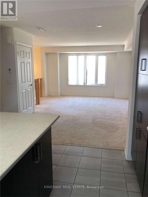 A kitchen with a counter top and a refrigerator.