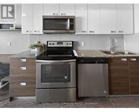 A modern kitchen with a stainless steel oven and microwave above a counter.