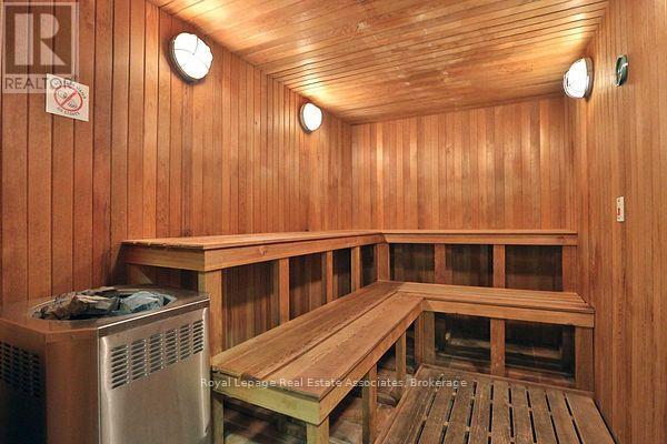 A sauna room with wooden walls and benches.