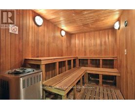 A sauna room with wooden walls and benches.