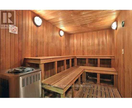 A sauna room with wooden walls and benches.