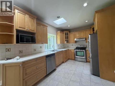 A kitchen with wooden cabinets and a white countertop.