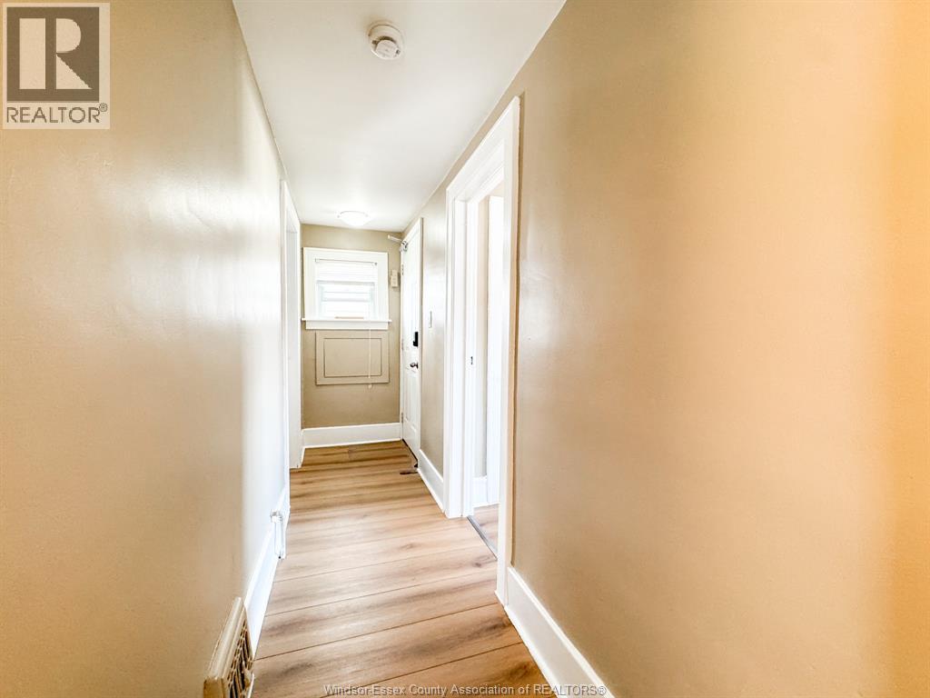 A hallway with a door on the right and a light on the ceiling.