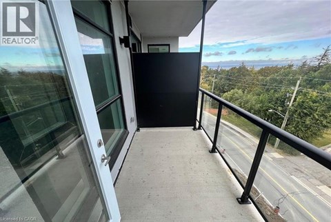 A balcony with a glass door leading to a black interior.