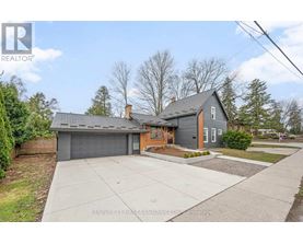 A house with a grey roof and a brown garage door is for sale.