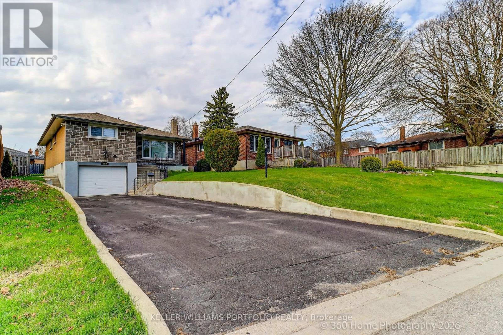 A residential area with a house and a driveway.