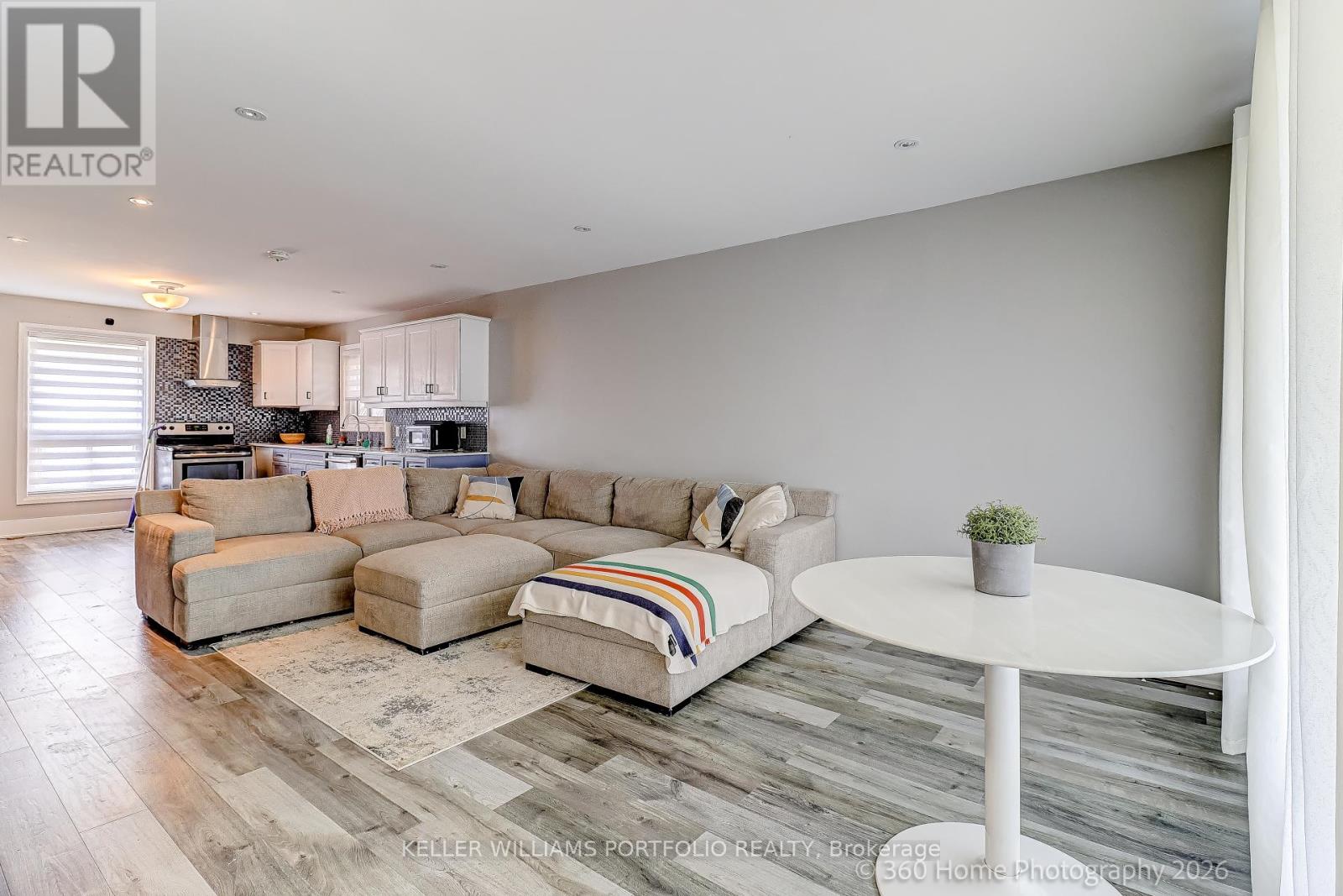 A living room with a white couch and a small table.