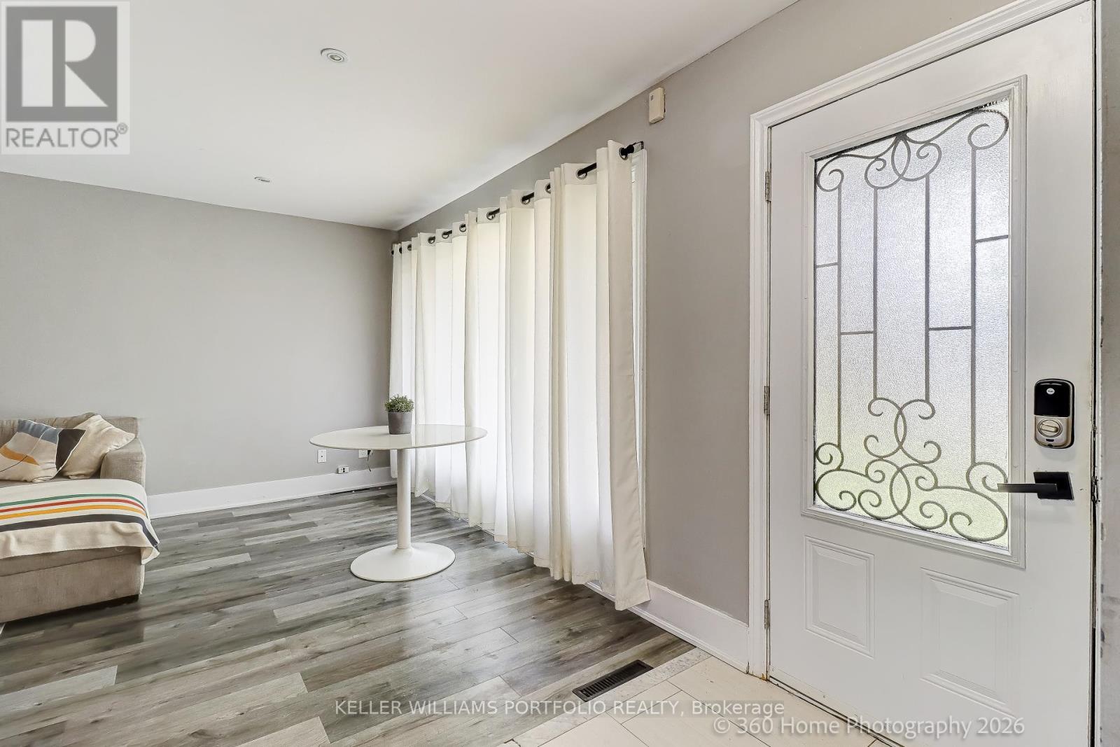 A white door with a glass window and a metal frame is on the right side of the image.