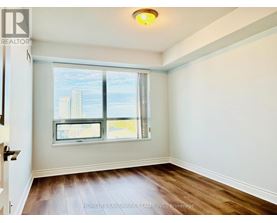 A room with a window showing a cityscape outside.