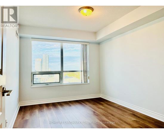 A room with a window showing a cityscape outside.