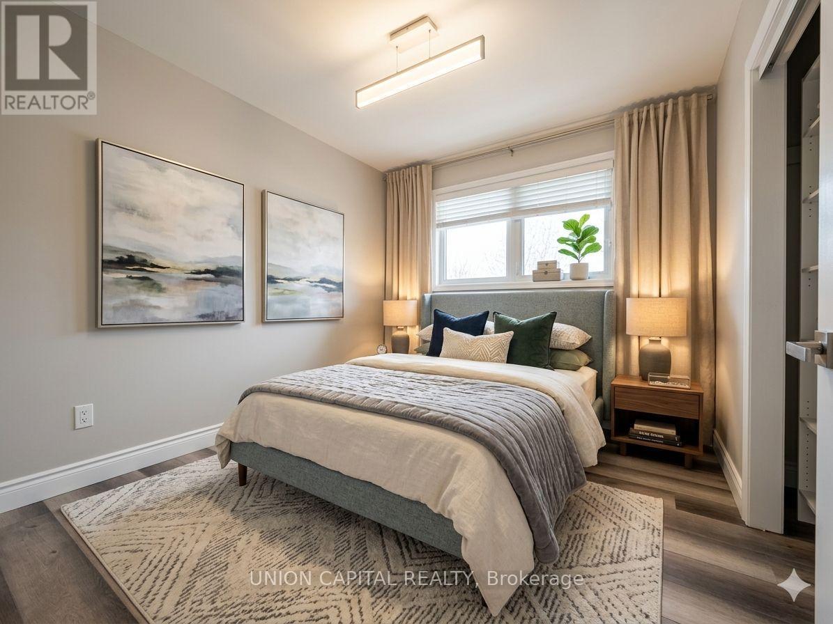 A bedroom with a large bed and two framed pictures on the wall.