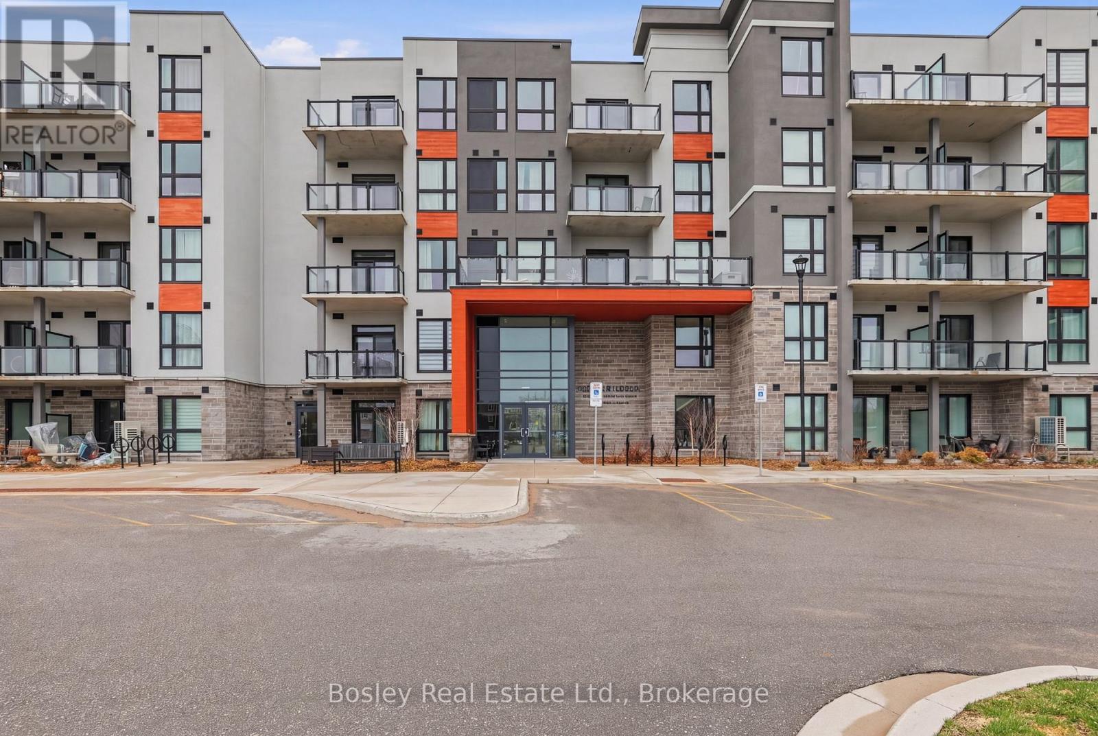 A large apartment complex with a red entrance and a sign that says "REALTOR".