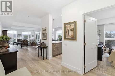 A living room with a white door and a painting on the wall.
