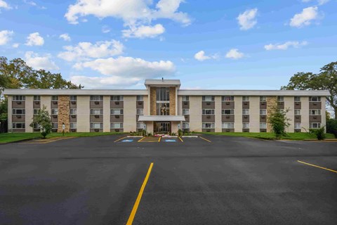 A large building with a parking lot in front of it.