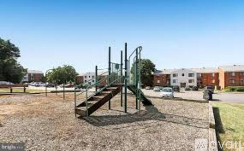 A playground with a slide and a wooden structure.