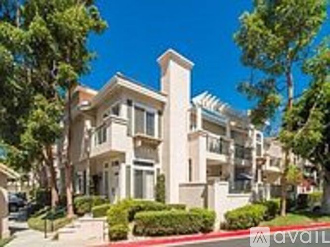 A large, multi-story residential building with a balcony on the second floor.