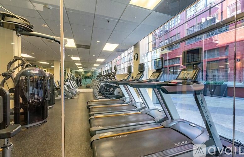 A gym with treadmills and elliptical machines.