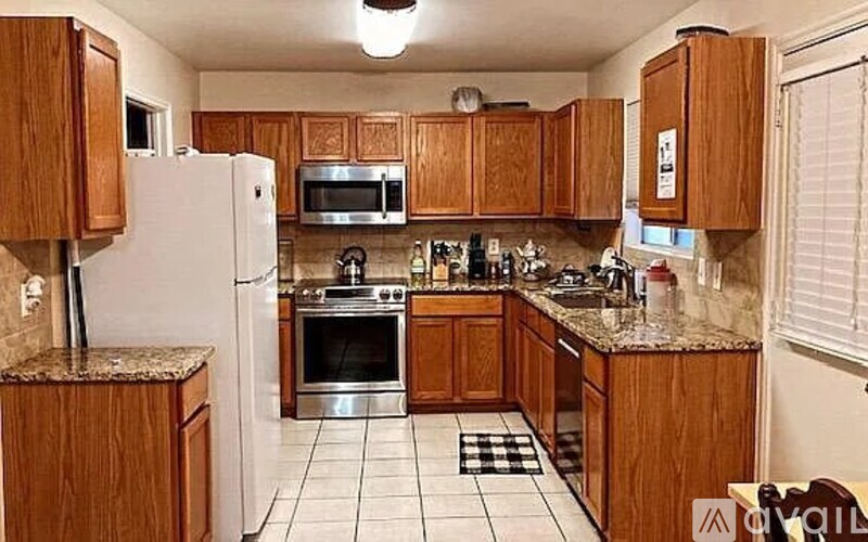 A kitchen with wooden cabinets and a white refrigerator.