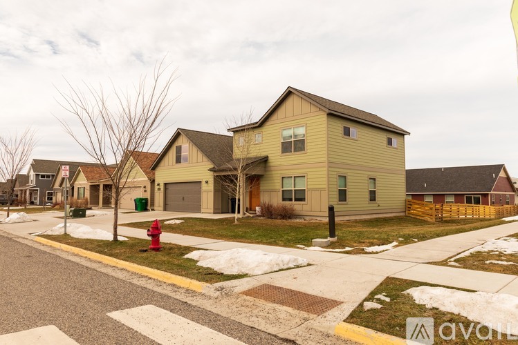 A row of houses with a red fire hydrant in front of them.