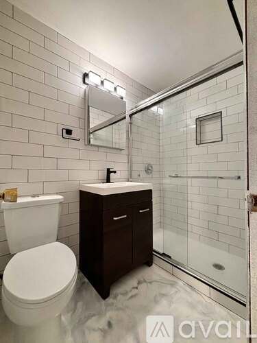 A white toilet sits next to a sink in a bathroom.